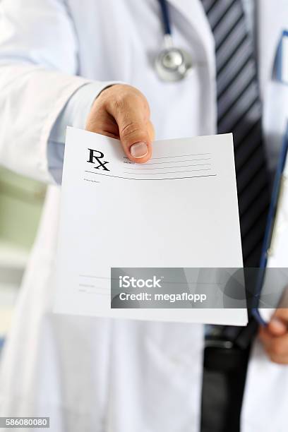 Male Medicine Doctor Hand Hold Clipboard Pad And Give Prescripti Stock Photo - Download Image Now