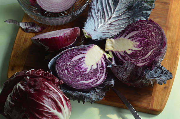 istock red cabbage halves on cutting board, red onion, radicchio 586083164