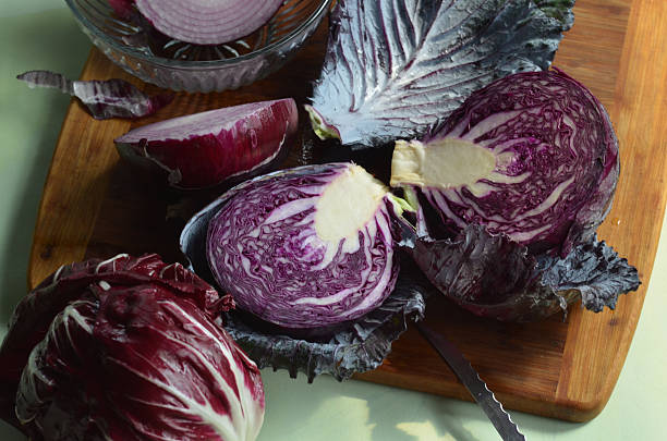 istock red cabbage halves on cutting board, red onion, radicchio 586083576