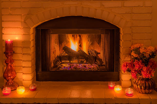 istock Cozy fireplace with flowers and candles (P) 586085374