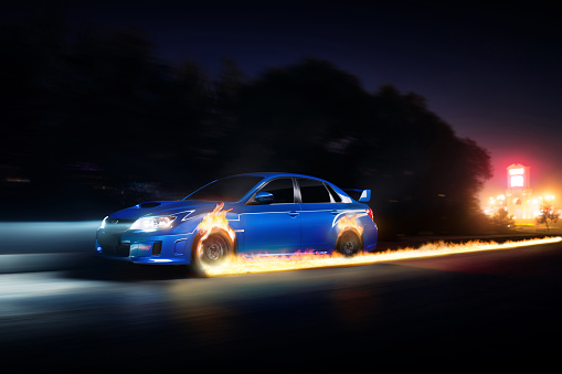Moscow, Russia - June 18, 2016: Blue car Subaru Impreza WRX STI drive on asphalt countryside road with fire wheels at night