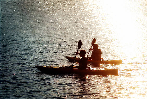 istock Father and son kayak at sunset 586086674