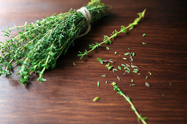 istock Fresh green bunch of thyme on wooden background 586086868