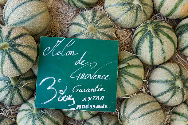 close up of a retail display of a pile of organically grown canary melons for sale at a farmer's market, Long Island, New York