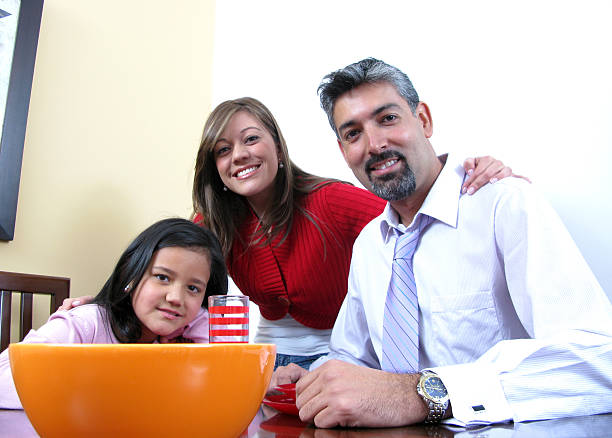 istock Family smiling and dining 586160064