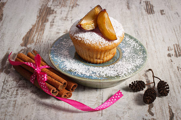 istock Muffins with plums and powdered sugar, cinnamon sticks 586160076