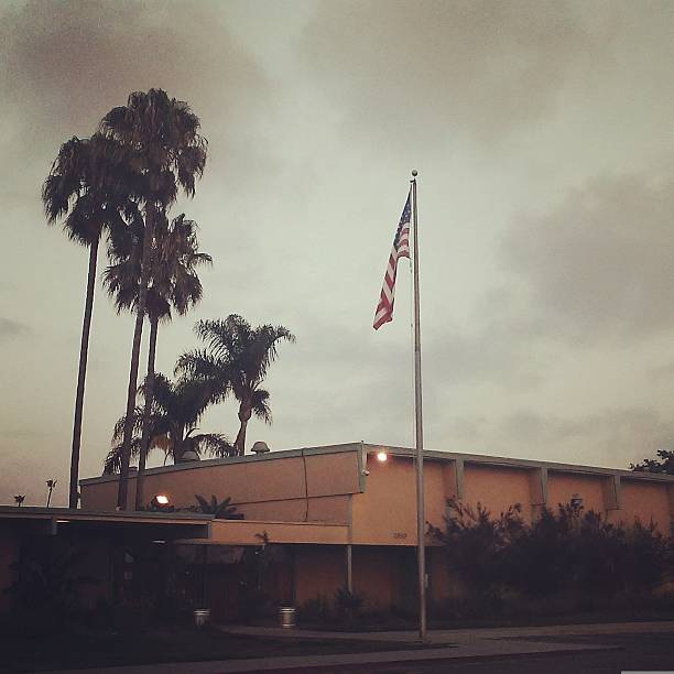 Shot of school building from the 1970s with an American flag in front.