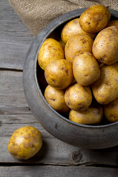 istock Fresh potatoes in old traditional Russian pot 586162682