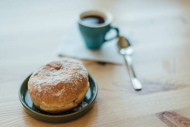 bismarck donut with coffee on wooden table for breakfast - bismarck donuts imagens e fotografias de stock