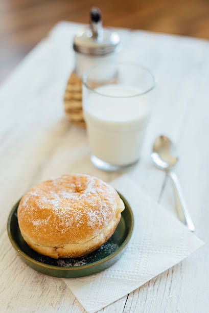 bismarck donut with coffee on wooden table for breakfast - bismarck donuts imagens e fotografias de stock