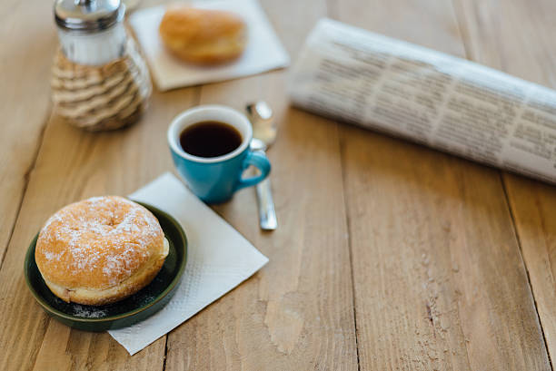 bismarck donut with coffee on wooden table for breakfast - bismarck donuts imagens e fotografias de stock