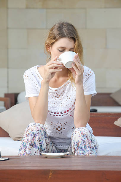 istock Young woman drinking coffee 586163940