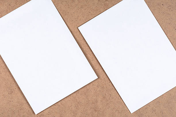 istock White blank paper sheets on the fibrous cardboard 586164112