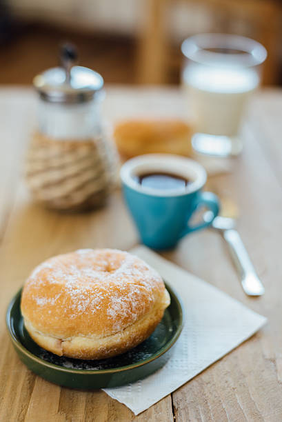 bismarck donut with coffee on wooden table for breakfast - bismarck donuts imagens e fotografias de stock