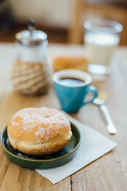 bismarck donut with coffee on wooden table for breakfast - bismarck donuts imagens e fotografias de stock