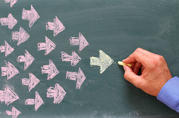 istock Leadership Concept image, male hand drawing arrows 586164580