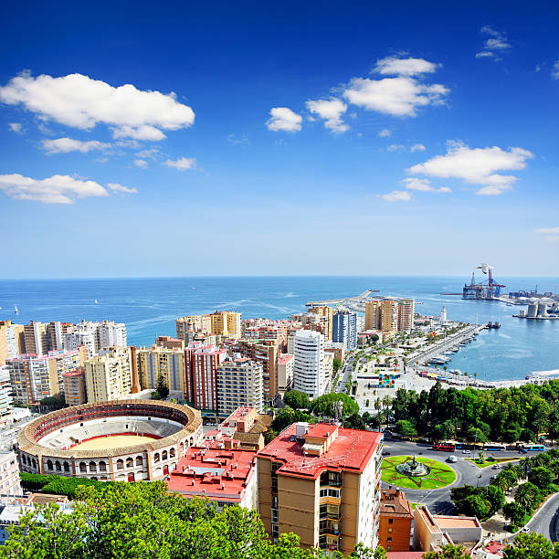 Malaga cityscape with Bullring of La Malagueta and harbor, Spain. Composite photo