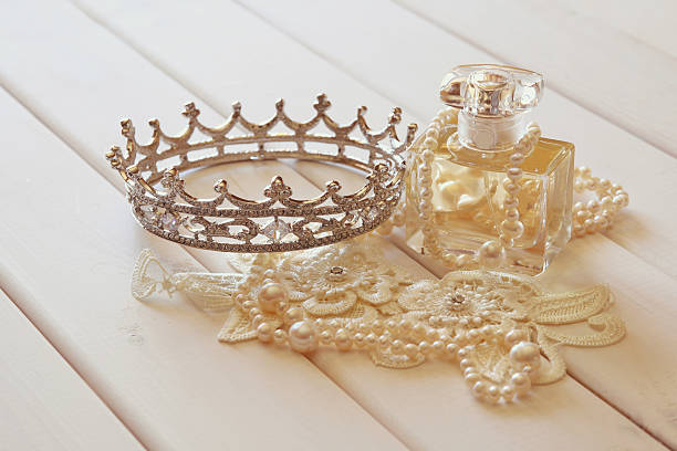 istock White pearls necklace, diamond tiara and perfume bottle 586165104