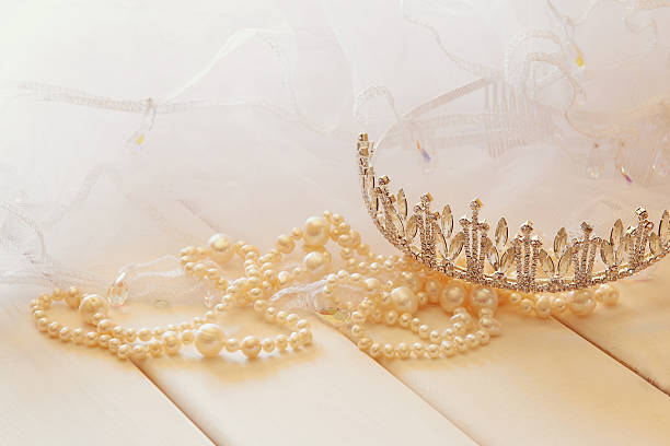 istock White pearls necklace and diamond tiara 586165178