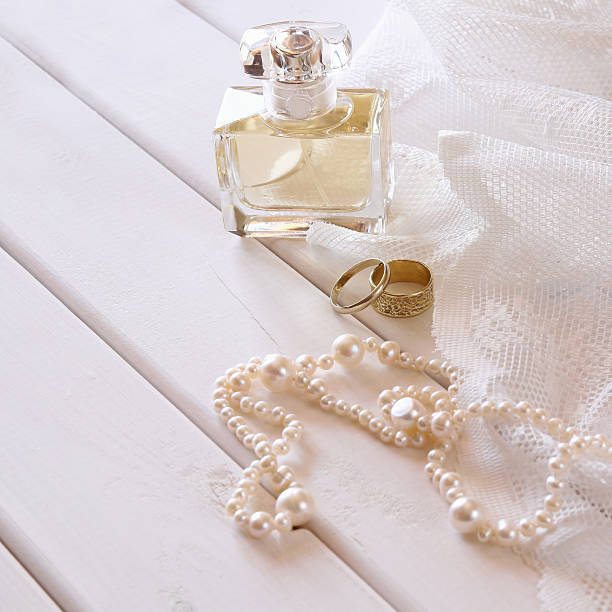 istock Rings and pearls necklace and perfume bottle 586165316