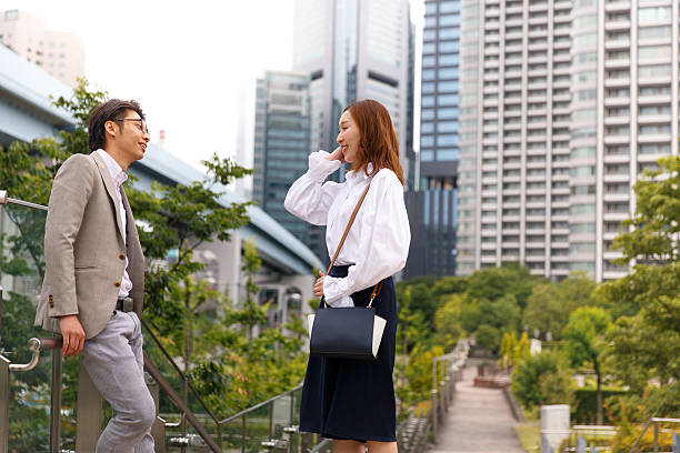 istock Two young business people talking green park 586165930