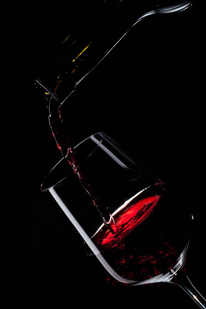 istock red wine pouring into glass 586166786