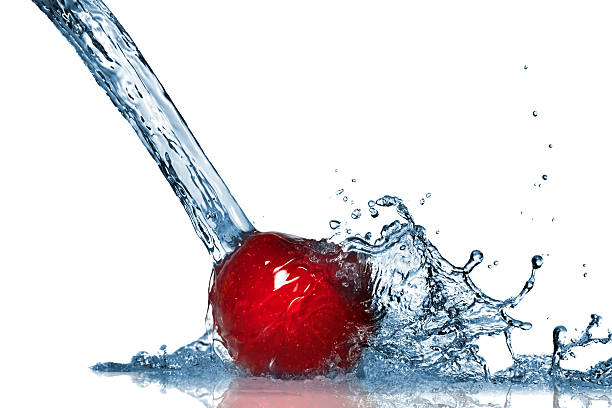 Red apple and water splash isolated on white