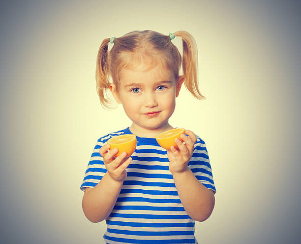 istock Little Funny girl keeps lemons 586166888