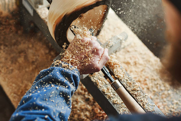 istock man working with woodcarving instruments 586168360