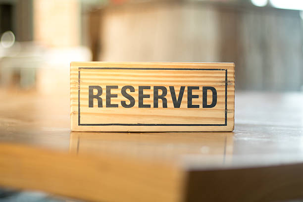 istock reserved sign made from wooden plate in restaurant 586169526
