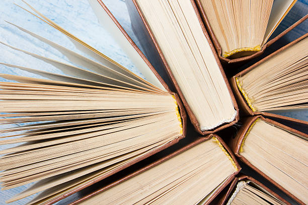 Open book, hardback books on wooden table. Back to school