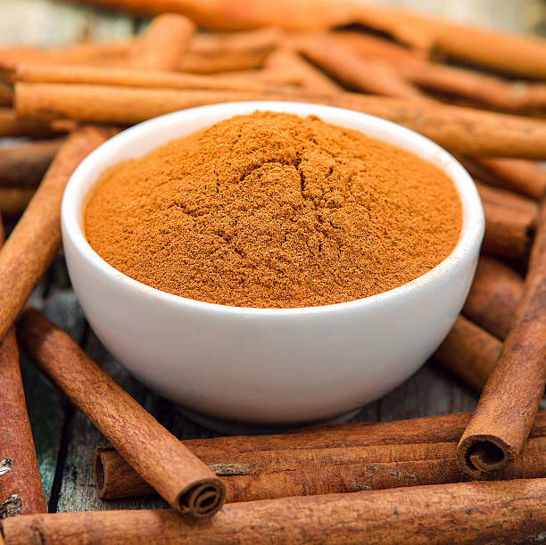 istock Cinnamon sticks and powder in the bowl on table 586174500