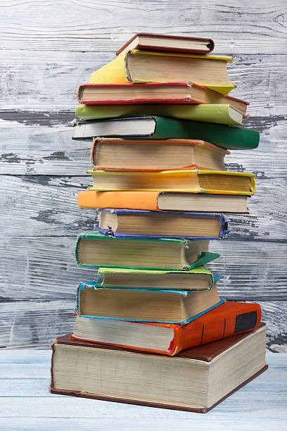 istock Stack of hardback books on wooden table. Back to school 586175144