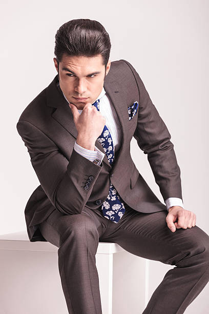 istock young business man sitting on a white chair 586175694