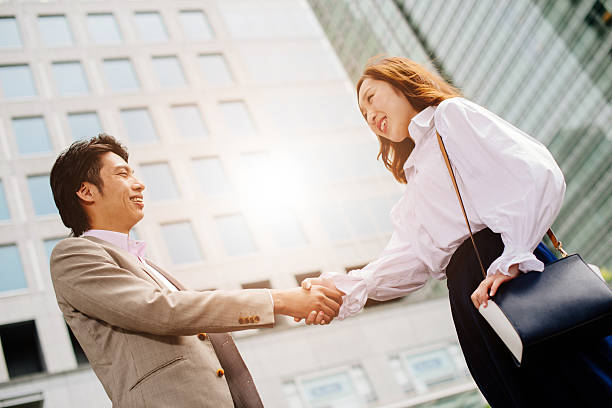 istock Young entrepreneurs in Tokyo handshake and smile 586176244