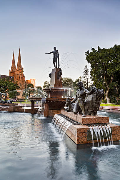 Sy HP Fountain Mary Vert sunset Public city park in Sydney - Hyde park, with fountain and st Mary cathedral in background. hyde park sydney stock pictures, royalty-free photos & images
