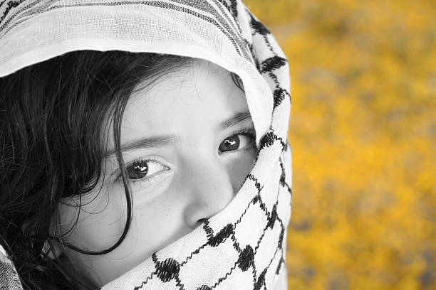 Afghan girl and (Arabic) kaffiyah Afghan girl and (Arabic) kaffiyah kaffiyeh stock pictures, royalty-free photos & images