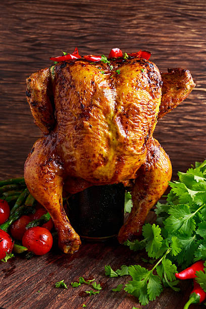 istock Gourmet Roast Whole organic chicken on cider Can With Asparagus 586177452