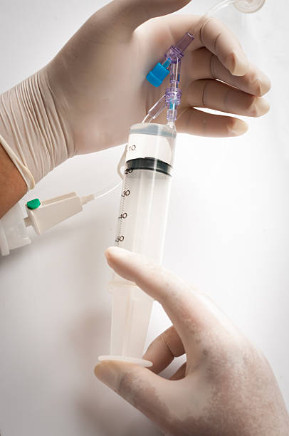istock Medical syringe connected to container with medication 586180284