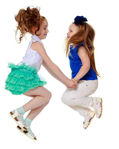 istock two girls jumping 586180526