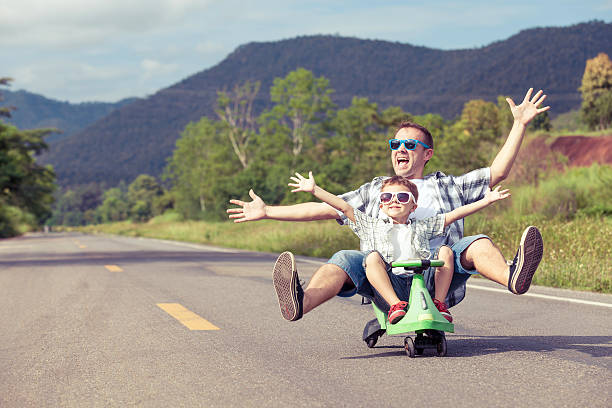 father and son playing on the road. - youth and age imagens e fotografias de stock