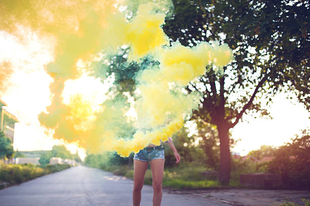 istock Girl using Colored smoke grenades outdoors 586185044