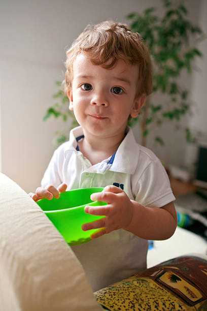 istock Little boy eating snack at home 586185116