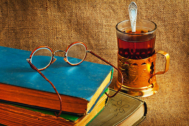 istock Old books, cup of tea and glasses 586189166