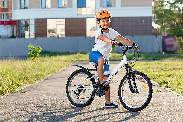 istock boy and bicycle outdoors 586189776