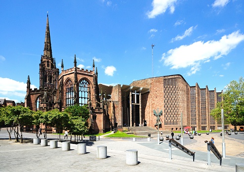 Coventry, United Kingdom - June 4, 2015: View of the old and new Cathedrals with people passing by, Coventry, West Midlands, England, UK, Western Europe.