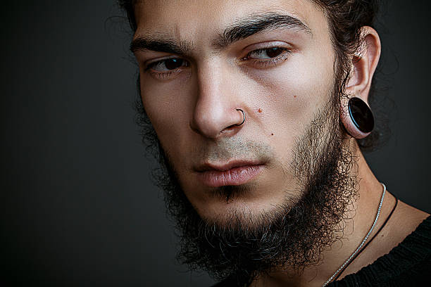 istock brutal young man with a beard against a dark background 586191658