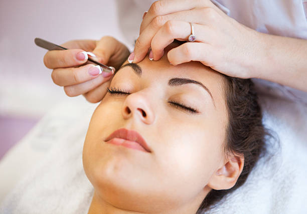 Beautiful young woman in cosmetic salon Portrait of a beautiful young woman in cosmetic salon. Close up. Beauty treatments eyebrow stock pictures, royalty-free photos & images
