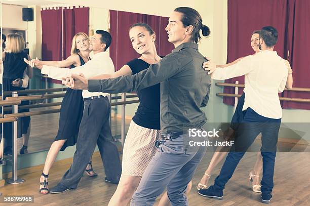 Men And Women Enjoying Of Tango In Class Stock Photo - Download Image Now - Dancing, Dance Studio, Tango - Dance