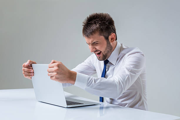 istock emotional man and laptop 586196004